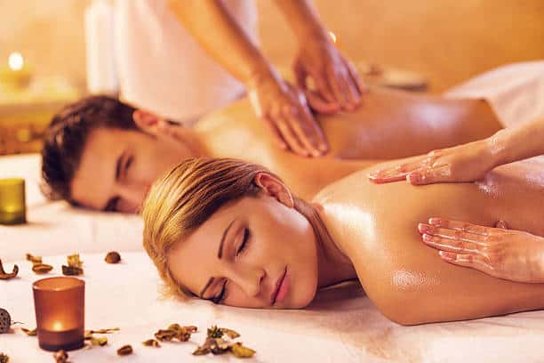 Young couple getting aroma oil massage .